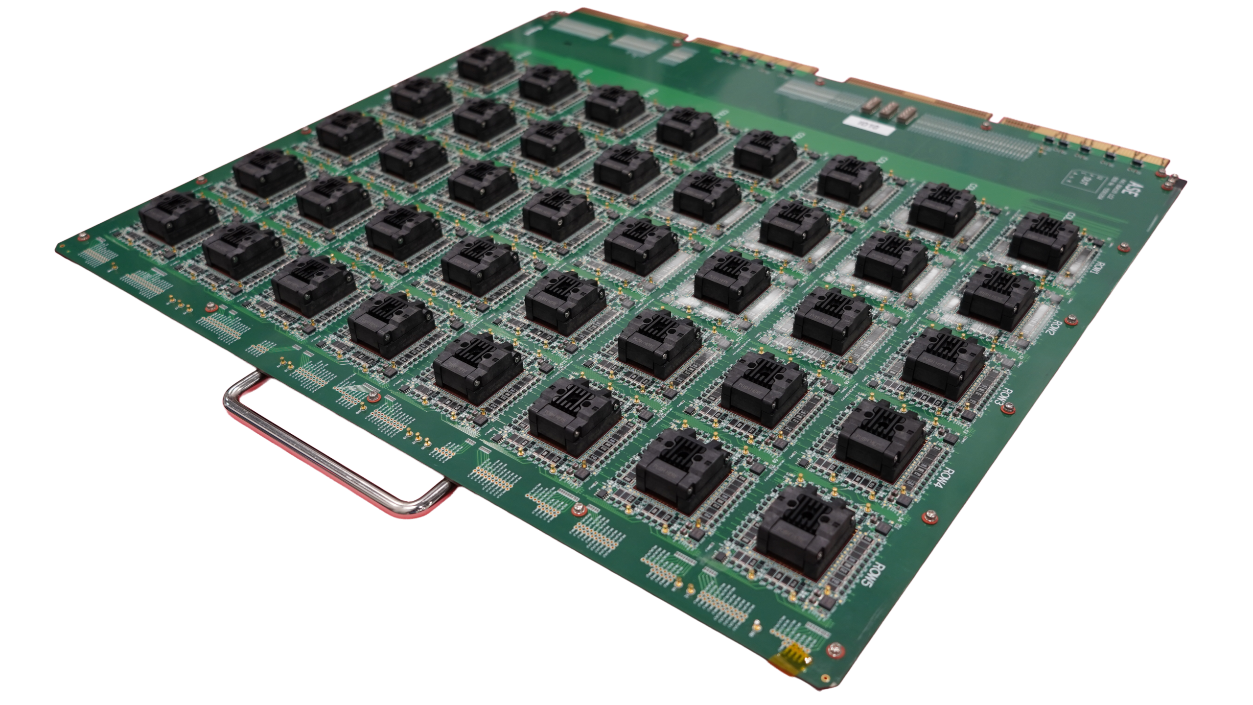 A large green circuit board populated with a grid of square black integrated circuit sockets and a metal handle.