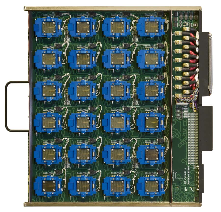 A circuit board featuring a grid of twenty-four blue processor sockets, with a connector port on the right side and a carrying handle on the left.