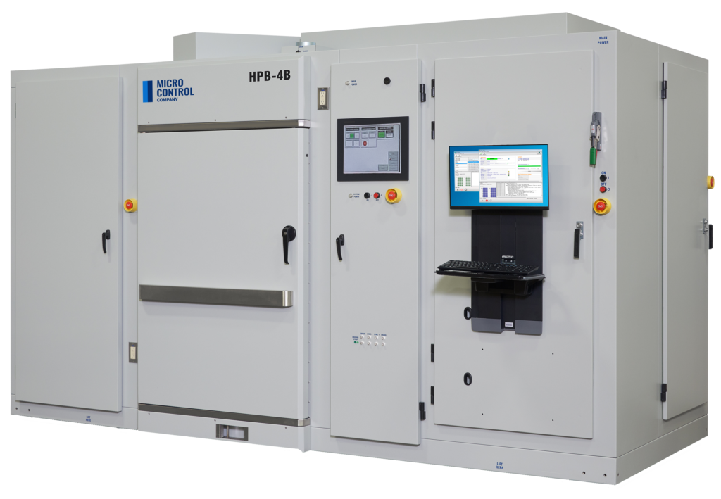 Micro Control Company HPB-4B industrial test chamber with a central touch-screen interface, computer monitor, and keyboard.